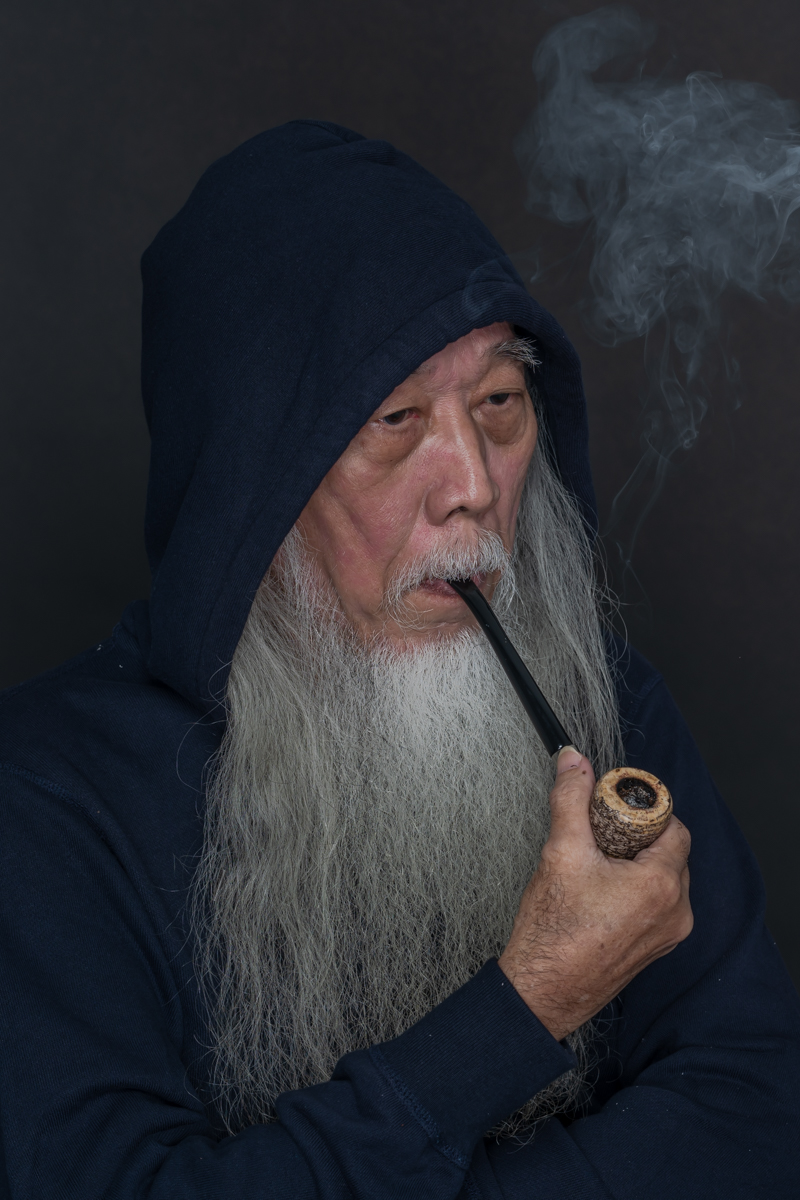 Man With A Long Beard Smoking A Pipe