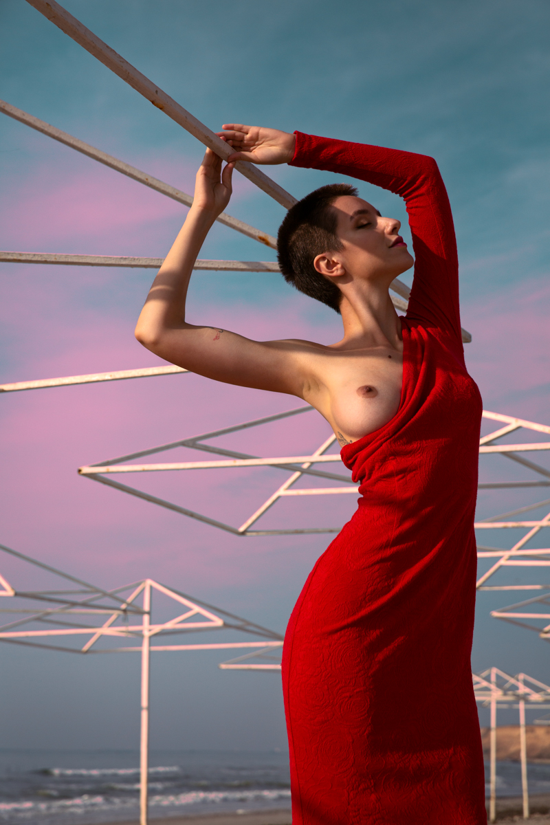 Black sea and girl in a red dress