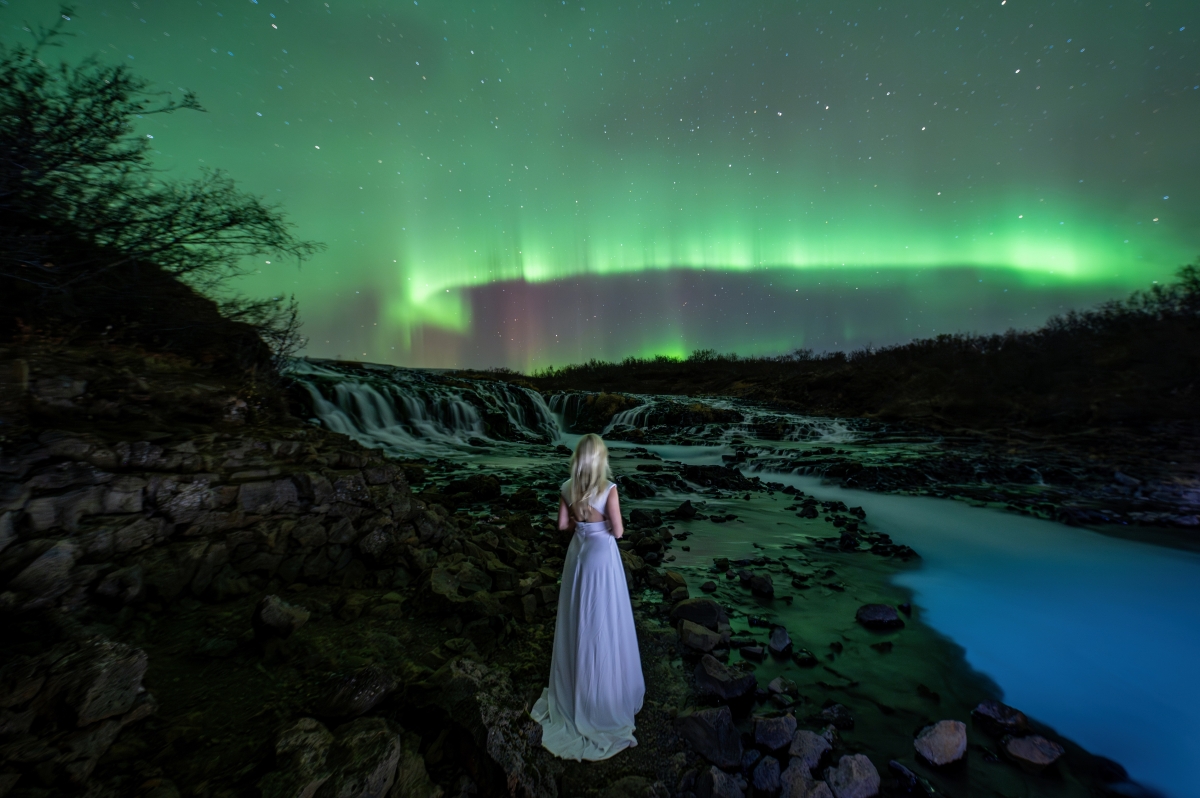 Lady Aurora over the Bruarfoss waterfall.