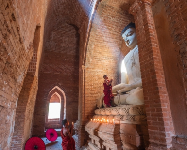 Novices praying with candle in Bagan