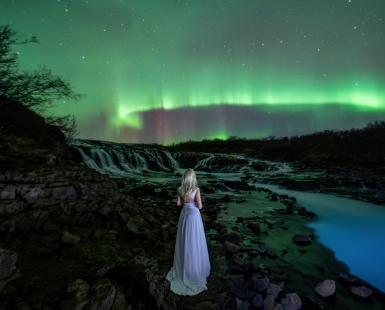 Lady Aurora over the Bruarfoss waterfall.